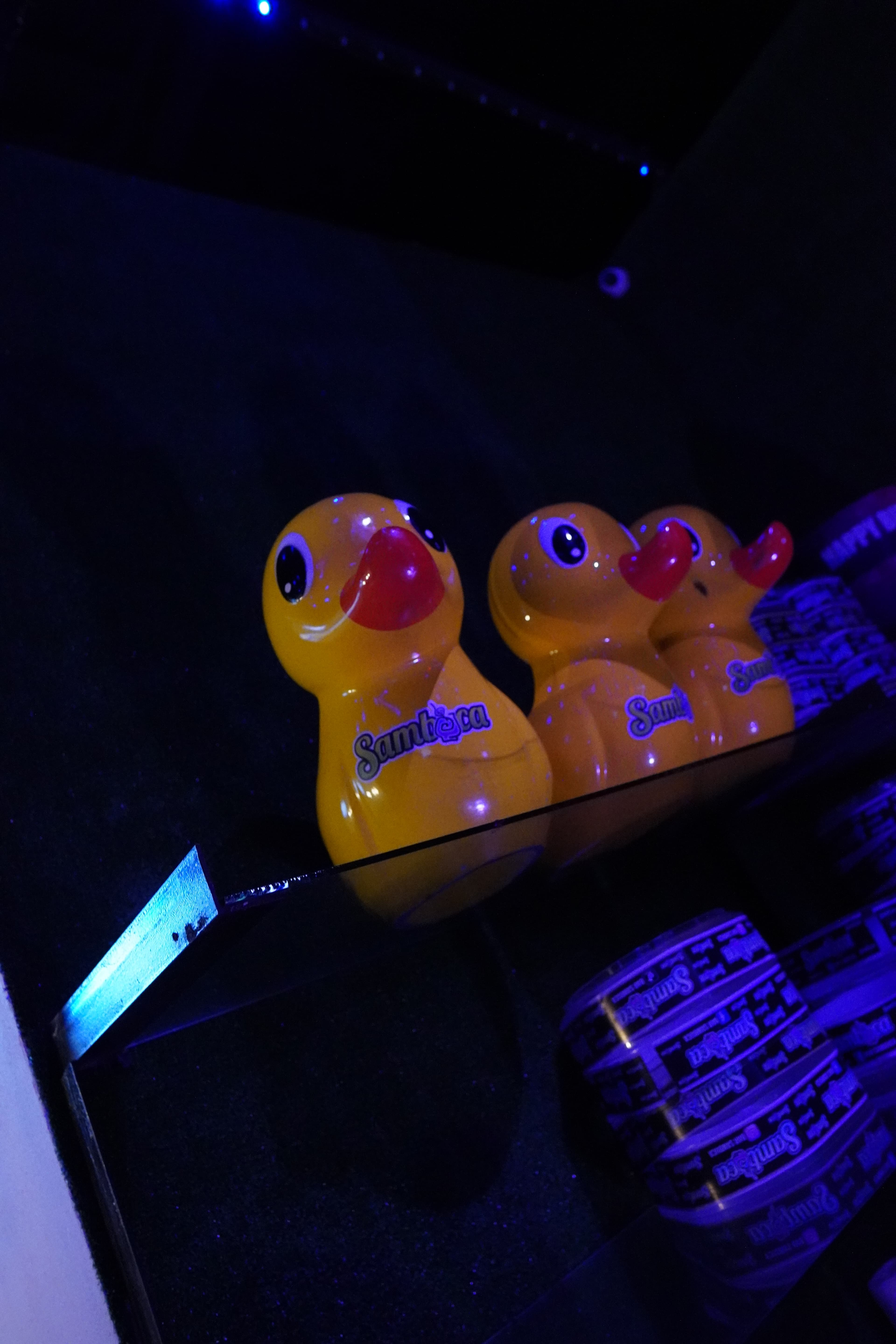A group of friends laughing and cheering with drinks at a bar.