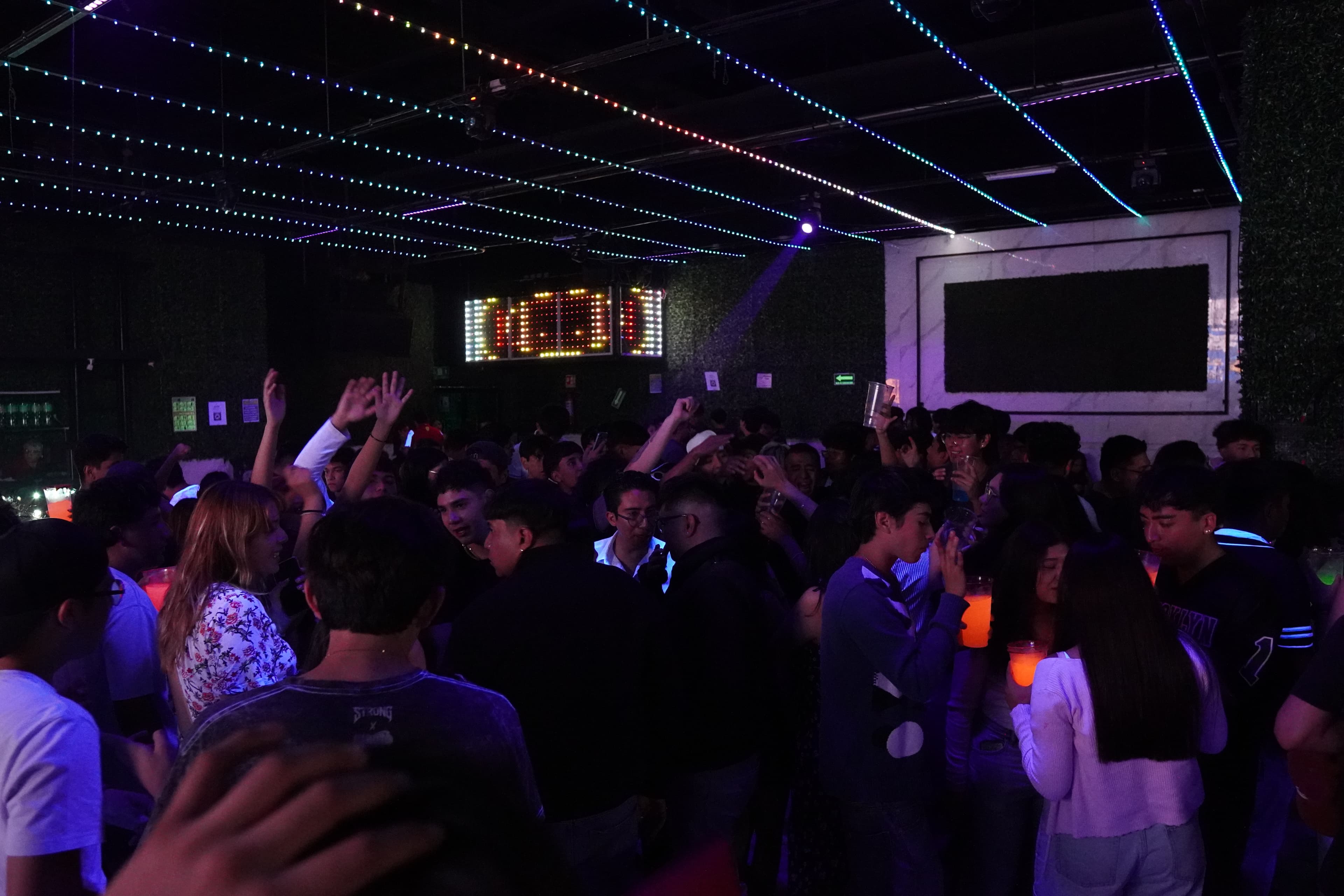 A delicious-looking plate of bar food, like wings or nachos, under warm light.