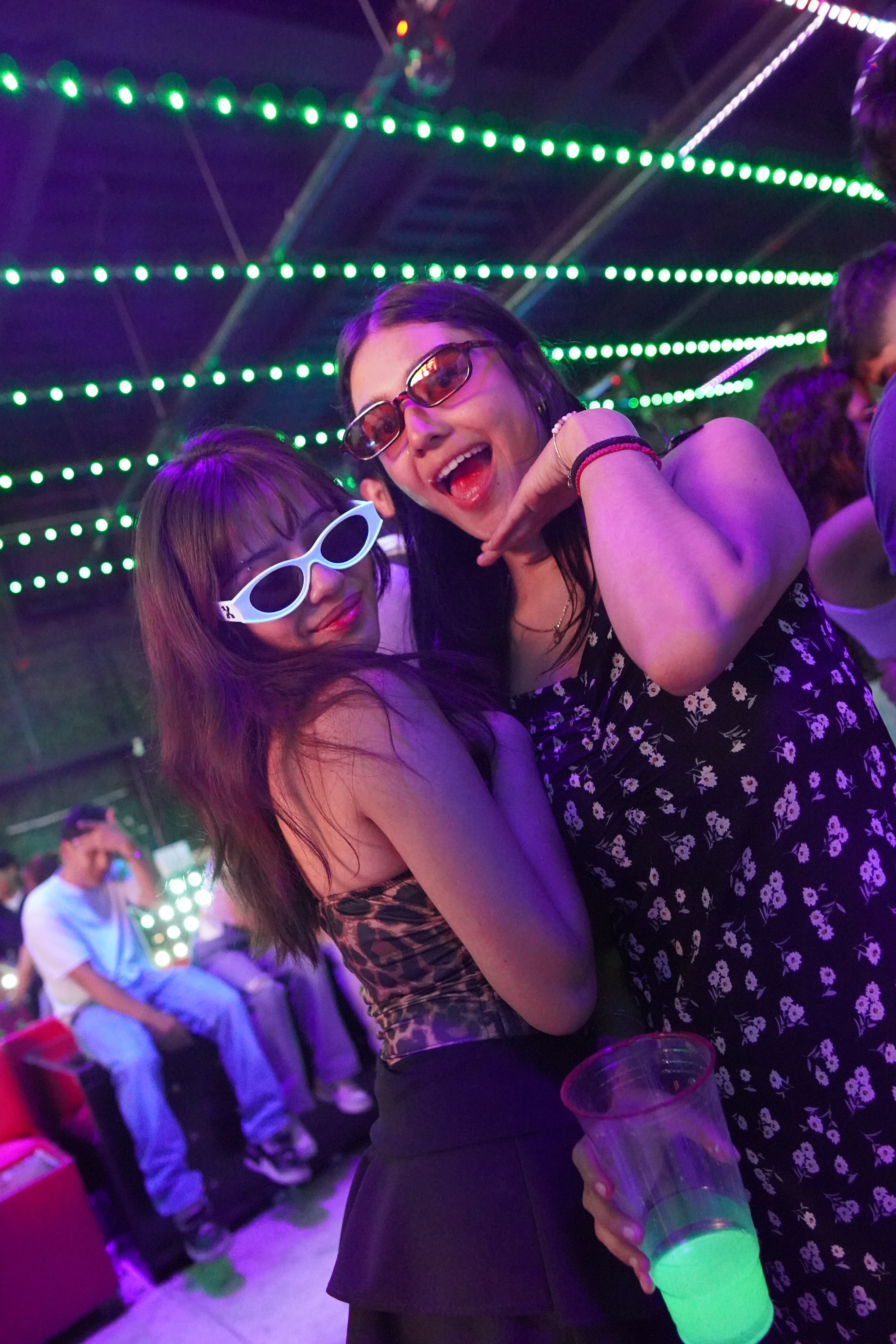 A neon sign that says 'Good Vibes Only' illuminating a brick wall.